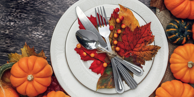 A Thanksgiving placesetting with decorative gourds