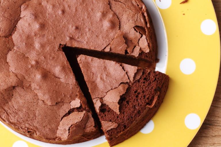 slicing into a gluten-free chocolate cake